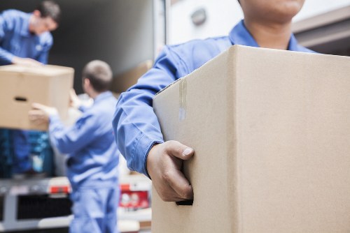 Professional packers handling office equipment