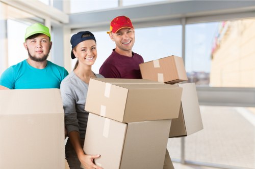 Professional movers loading office equipment into truck